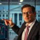 Financial analyst discussing urgent Fed rate cuts during market analysis
