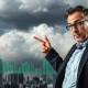 Economist analyzing critical recession risks through economic data charts and indicators