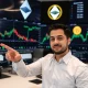 Economist analyzing crypto bull cycle trends with market charts showing Ethereum and Bitcoin performance