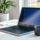 Dell Inspiron work laptop on professional desk setup for remote productivity