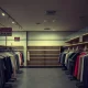 Fashion retail store undergoing Chapter 7 bankruptcy liquidation with empty racks and closure signs