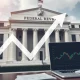 Federal Reserve building with economic data charts showing impending rate cut decision