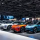 German automakers showcasing electric vehicles at international automotive conference with investment backdrop