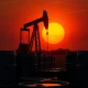 OPEC+ output decision amid oil oversupply crisis with pumpjack and barrels