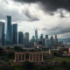Critical recession prediction showing economic prosperity turning into decline with storm clouds gathering over city skyline
