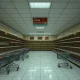 Empty retail store showing recent closures with abandoned shopping carts and clearance signs