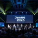 StockPil Disrupt 2025 conference stage with tech leaders presenting to engaged audience
