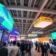 Entrepreneurs networking at StockPil Disrupt 2025 tech conference exhibition hall