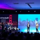 StockPil Disrupt 2025 conference stage with tech leaders presenting to large audience