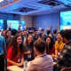 Volunteers collaborating at StockPil Disrupt 2025 tech conference helping startups and innovators