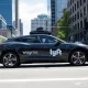 Waymo and Lyft autonomous robotaxi service vehicle driving in Nashville city streets