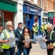 Small business owners discussing Pride in Place regeneration opportunities on revitalized high street