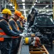 UK automotive supply chain workers addressing manufacturing challenges in modern factory