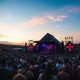 Glastonbury Festival's Pyramid Stage during a headline performance, symbolizing record profits and charity impact.