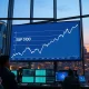 S&P 500 index achieving a historic milestone on a trading floor data screen